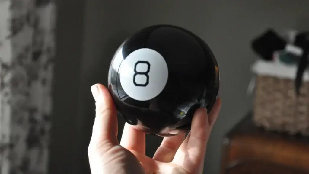 showing the Front side of the Magic 8 ball in one hand 